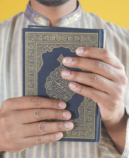 muslim-man-hand-holding-holy-book-quran-with-copy-2023-11-27-05-20-08-utc